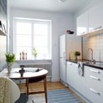 Snow-white kitchen with a semicircular table near the accent wall