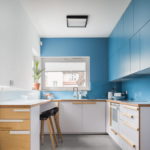 Beautiful kitchen with blue facades and white ceiling