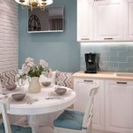 Small kitchen with a round table and sofa