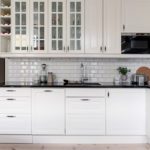 Small white kitchen with glass cabinets