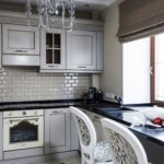 A small kitchen with a table instead of a window sill
