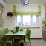 Bright small kitchen with green furniture and curtains