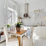 Cozy white kitchen with natural wood furniture