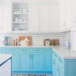 Cozy kitchen in light blue tones and marble countertops.