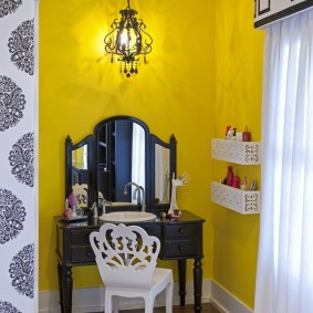 โต๊ะเครื่องแป้งสีดำบนพื้นหลังของผนังสีเหลือง